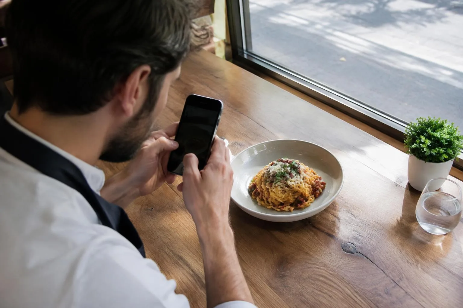 Restaurant Owner Photographing a Dish in Natural Light